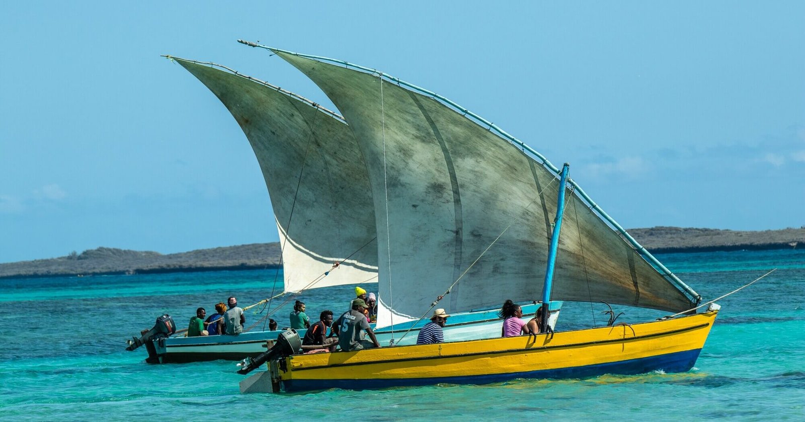A boat with two sails gliding across the water