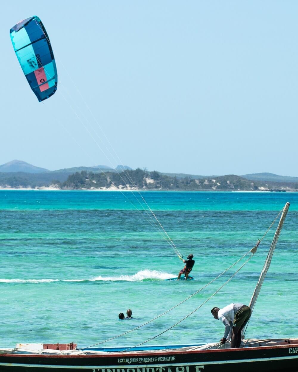A man is parasailing high above the ocean