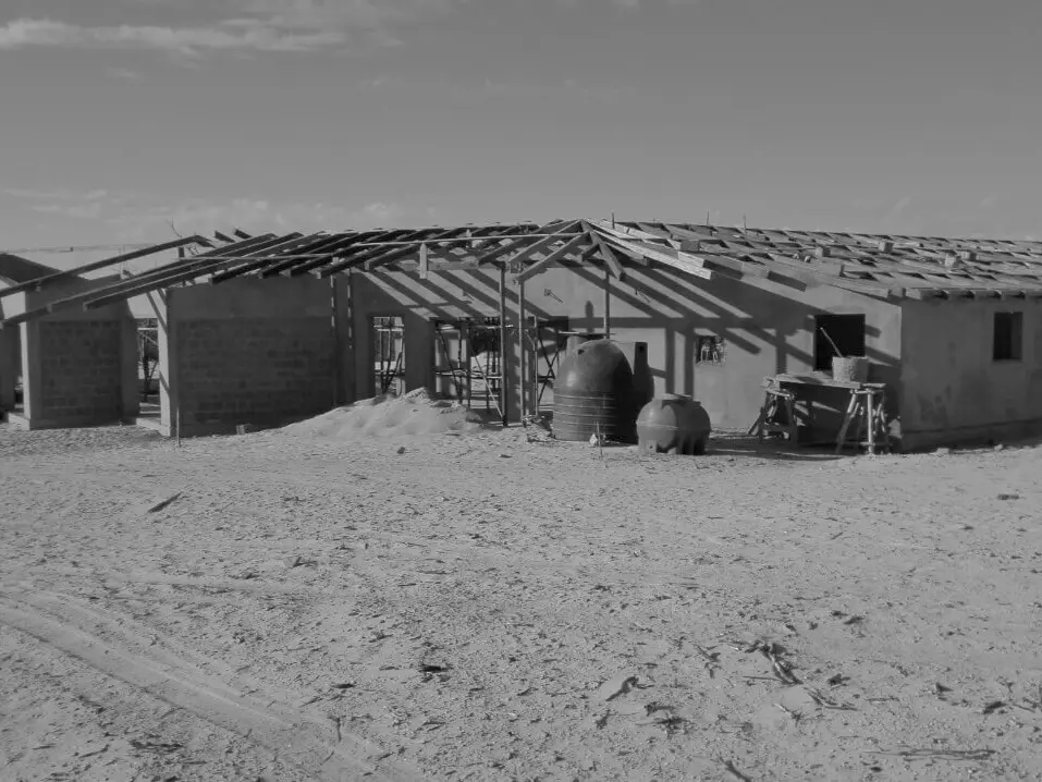 A partially constructed house with a wooden frame