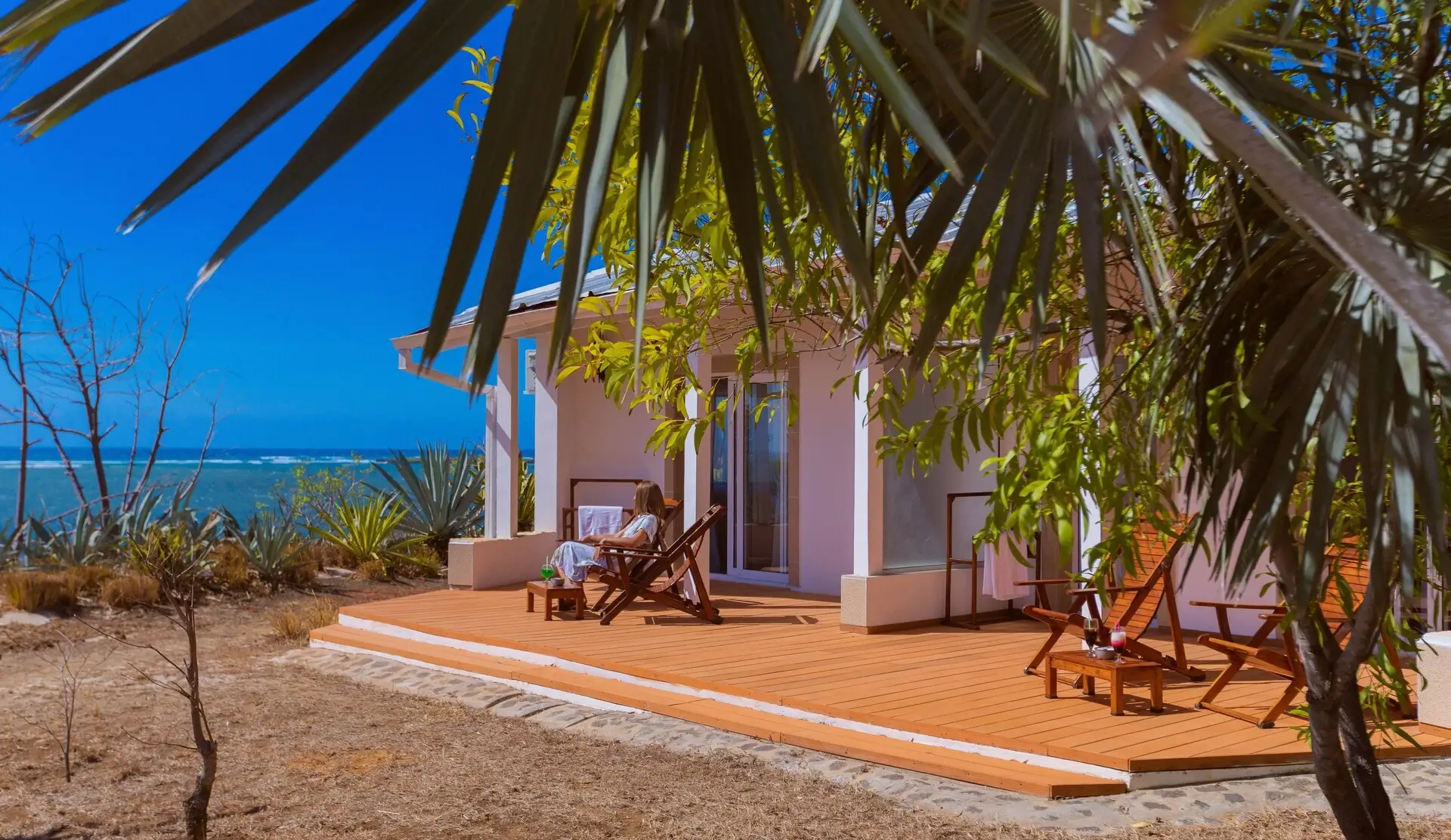 A tranquil beachfront cottage with a wooden deck