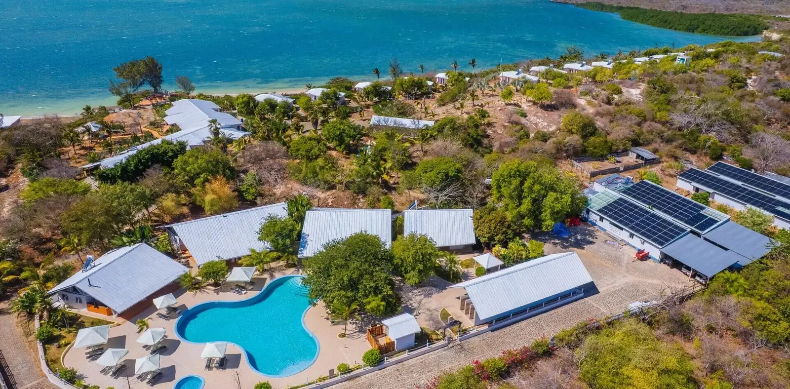 Aerial view of a resort featuring solar panels on rooftops