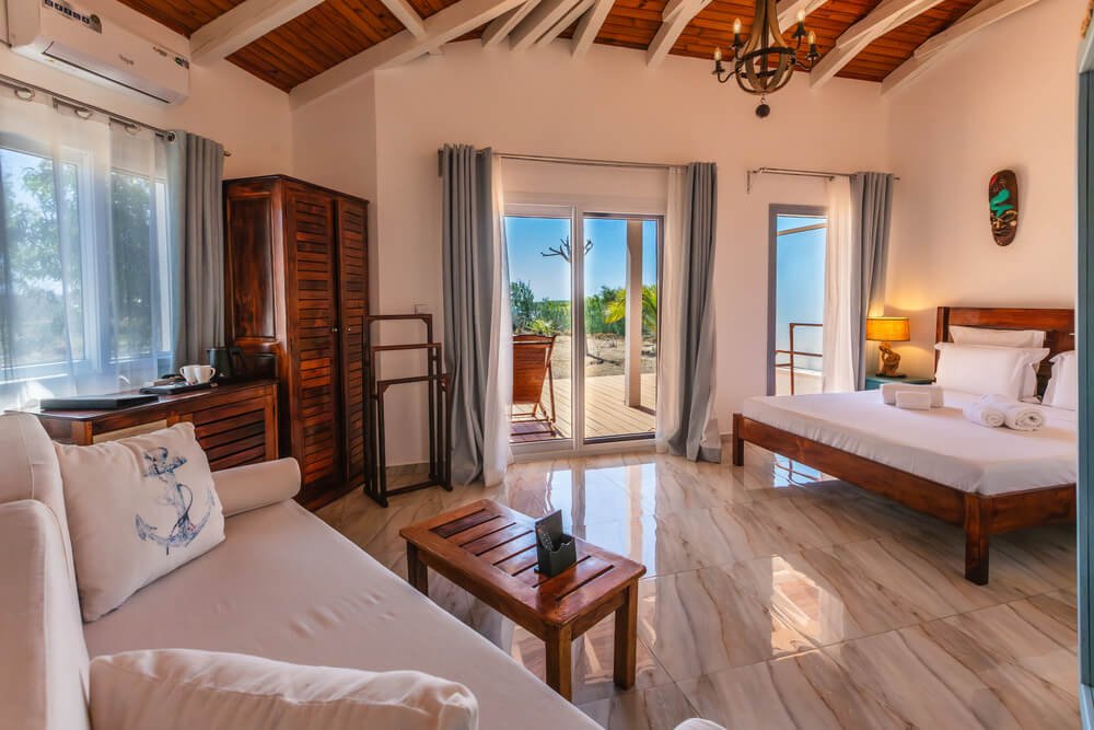 Bright, airy room with wooden accents, a cozy bed