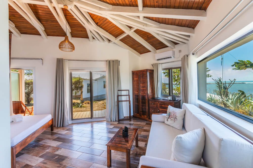 Bright and airy coastal living room with wooden beams