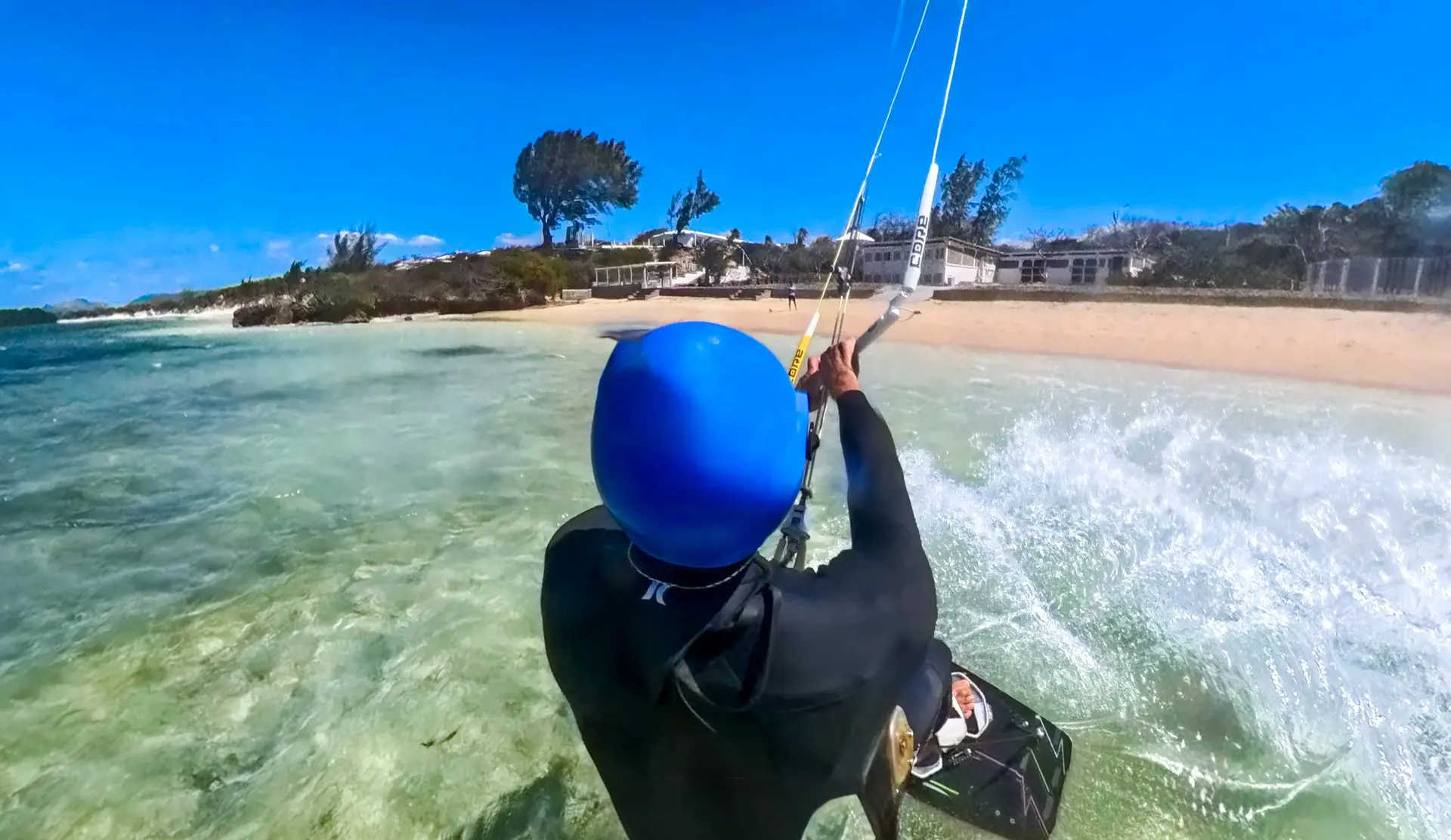 Kitesurfer riding waves near beach